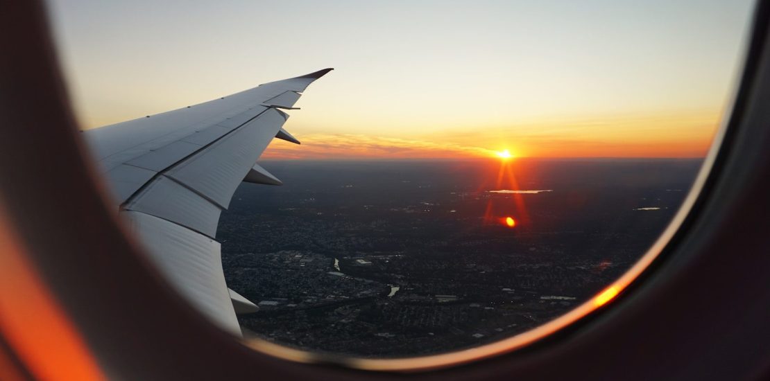 airplanes window view of sky during golden hour