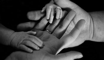 babys hand on human palm