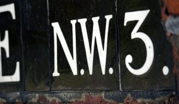 Close-up of a sign with letters nw3