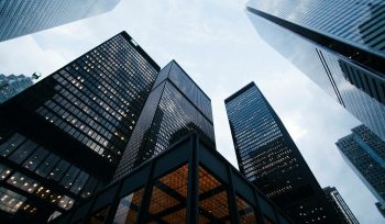 Low-angle view of modern financial district skyscrapers representing structured income programmes and institutional investment strategies for high-net-worth investors
