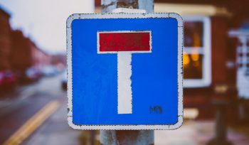 white, blue, and red road sign near road