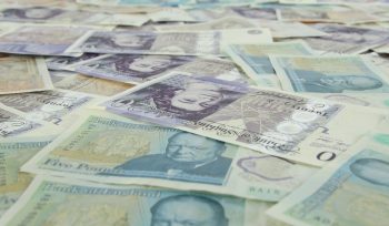5 pieces of banknotes on yellow and white textile