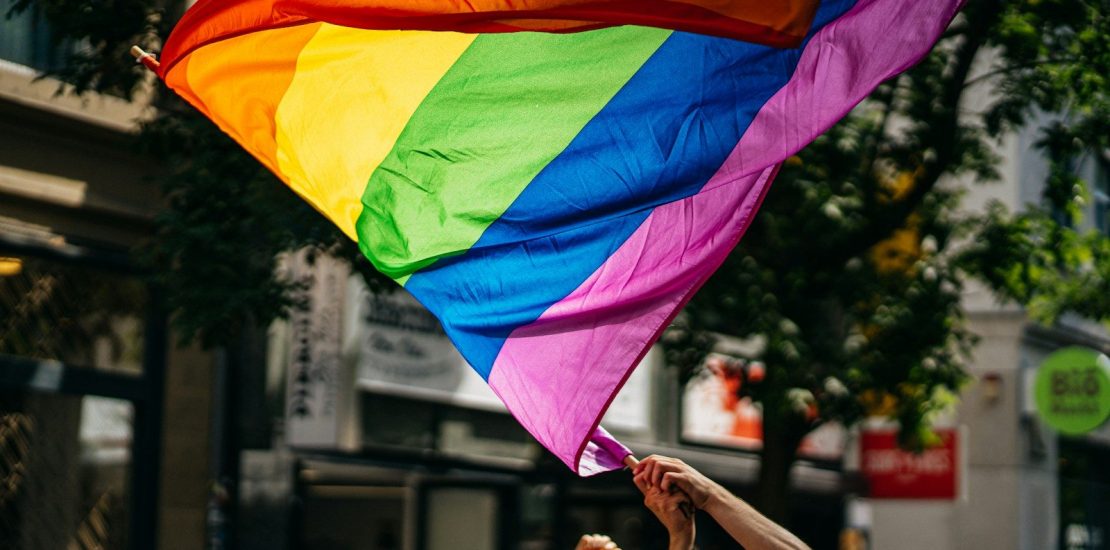 people holding flags during daytime for LGBTQ investors