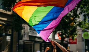 people holding flags during daytime for LGBTQ investors