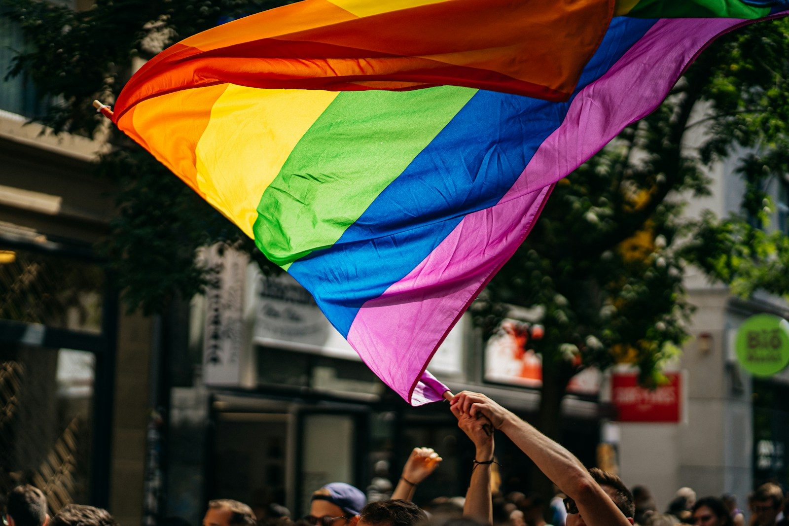 people holding flags during daytime for LGBTQ investors