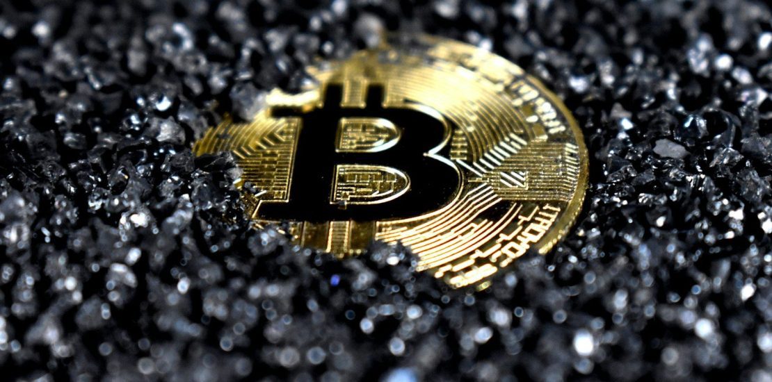 Gold Bitcoin cryptocurrency coin on dark gravel background, representing digital asset inheritance and what happens to your crypto and Digital assets when you die