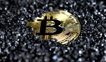 Gold Bitcoin cryptocurrency coin on dark gravel background, representing digital asset inheritance and what happens to your crypto and Digital assets when you die