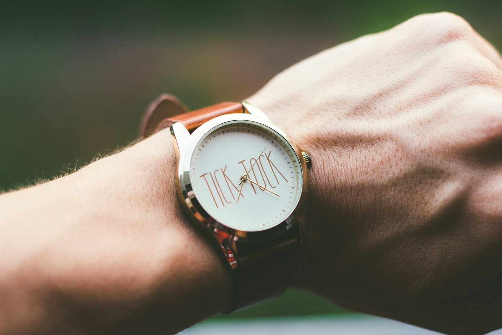 person wearing silver and white analog watch. Sold house listing beside a Will, illustrating how an out-of-date Will can leave inheritance wishes unfulfilled.