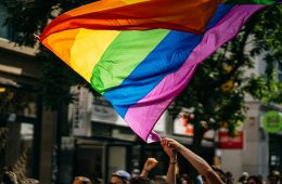 people holding flags during daytime for LGBTQ investors